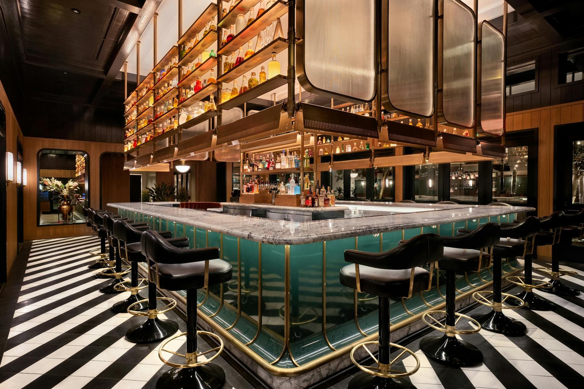 The warmly lit green marble bar at Twelvemonth